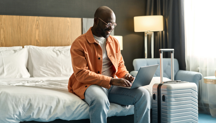 Hotel guest accessing WiFi from a laptop in their room
