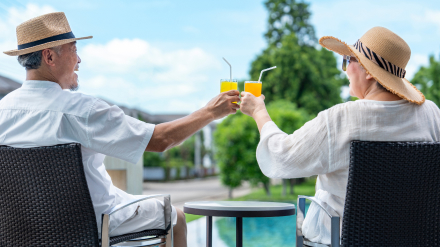 Two hotel guests enjoying a drink poolside